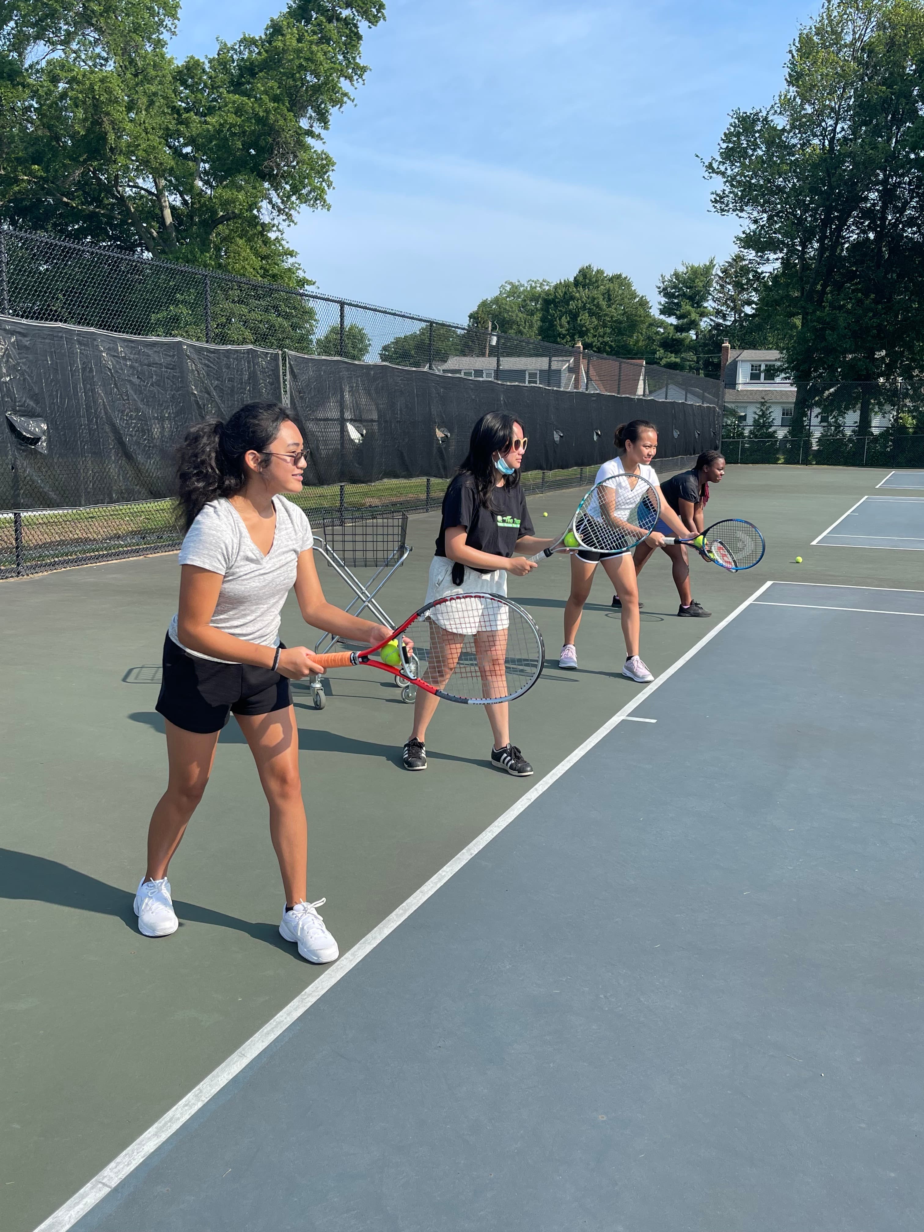 Young people practicing tennis