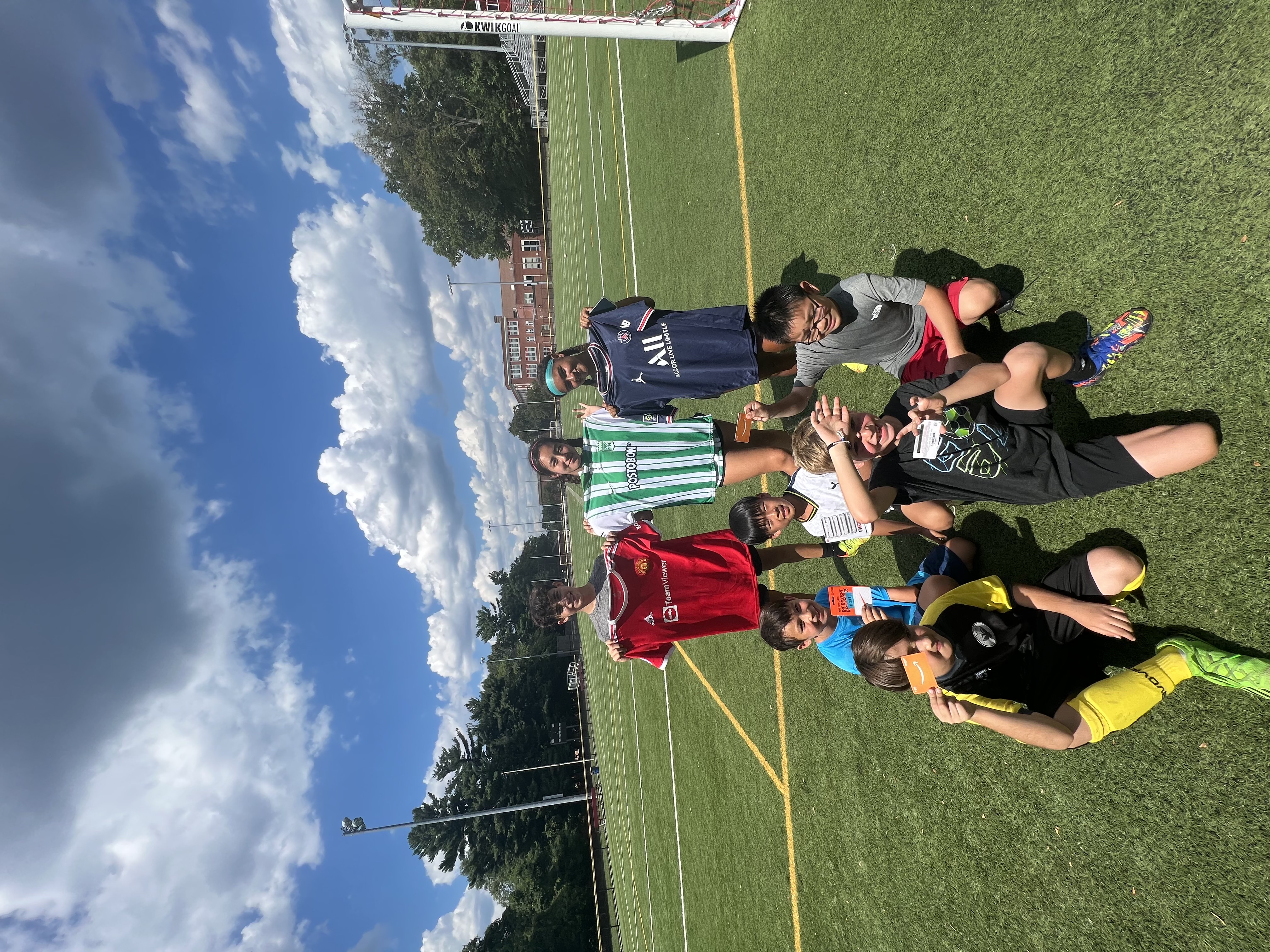 Children at our soccer camp showing team jerseys