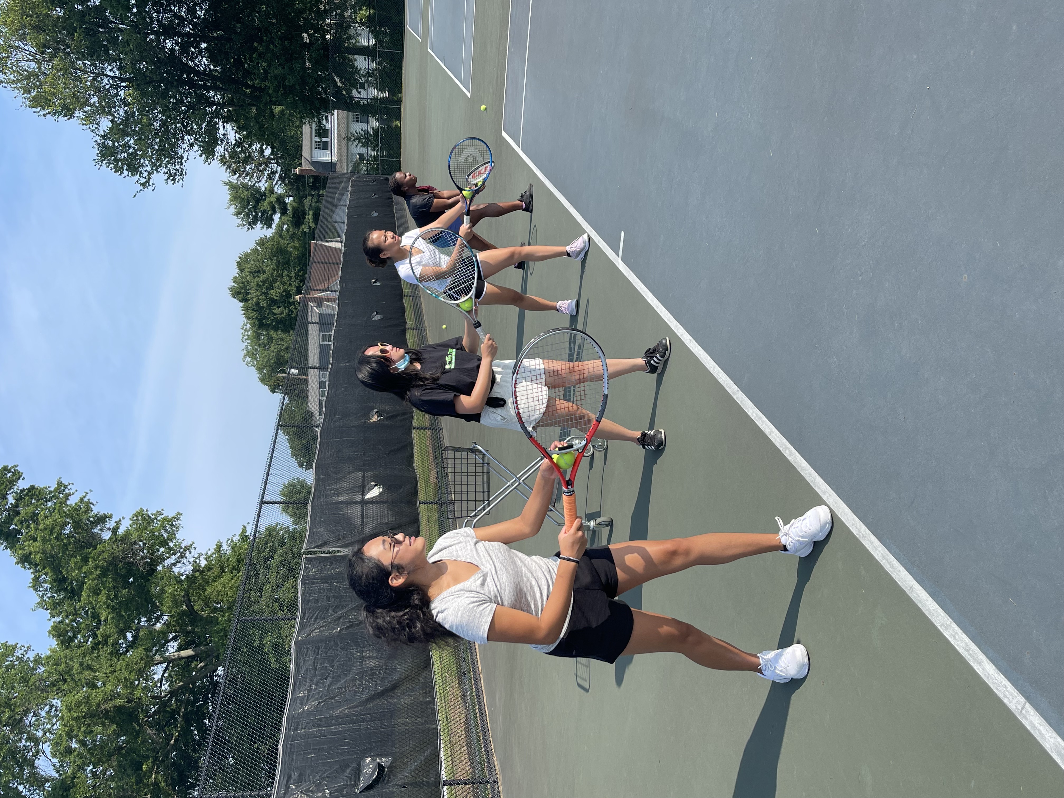 Young people practicing tennis